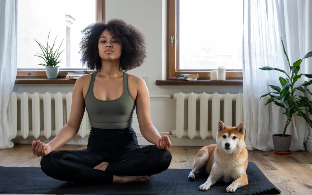 Woman meditating with dog